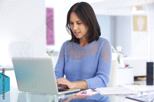 Woman Working At Laptop In Home Office