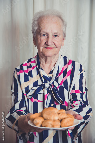 Senior woman giving cookies