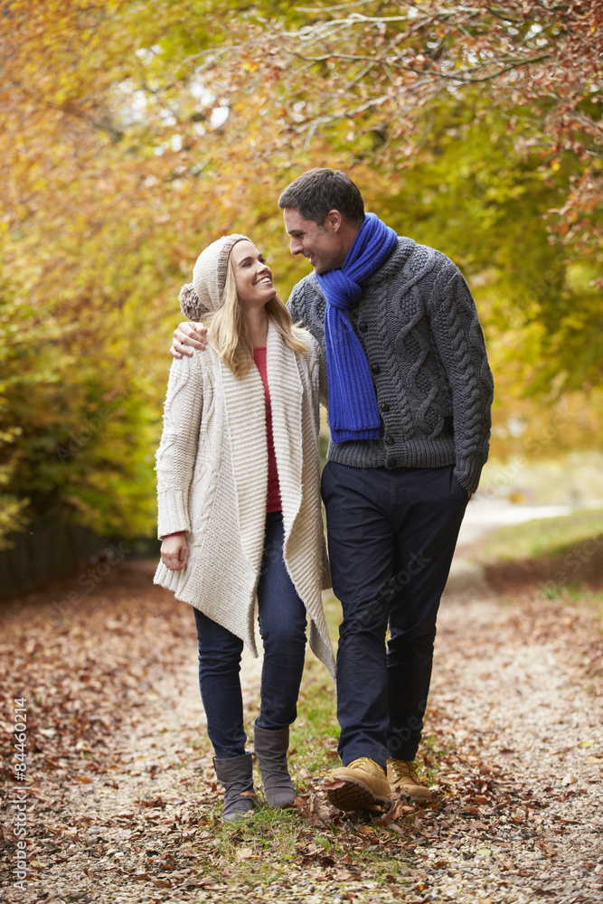 Fototapeta premium Couple Walking Along Autumn Path
