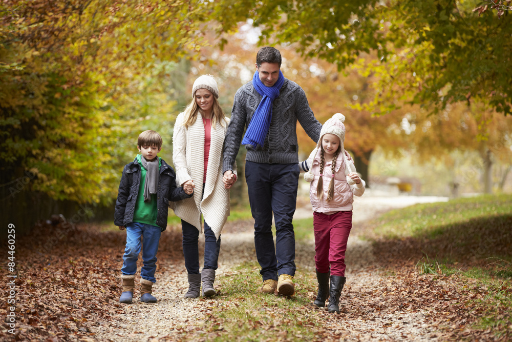 Family Walking Along Autumn Path Family Walking Along Autumn Path