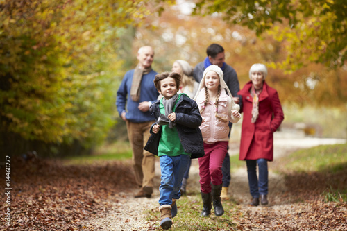 Multl Generation Family Walking Along Autumn Path © Monkey Business