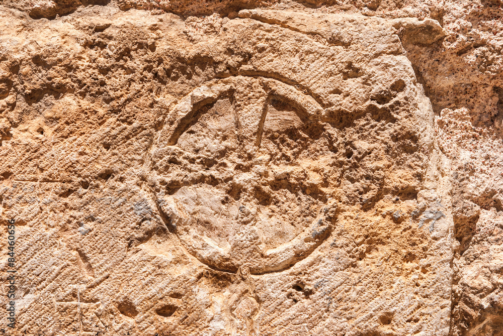 Obraz premium Christian cross of stone wall of the Church of the Holy Sepulchre