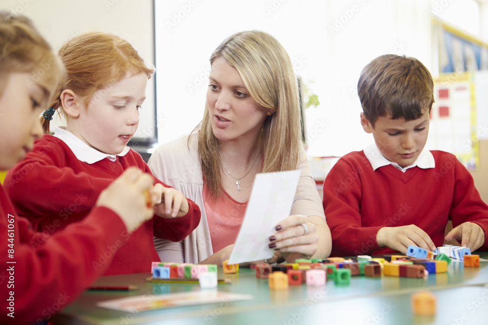 Fototapeta premium Pupils And Teacher Working With Coloured Blocks