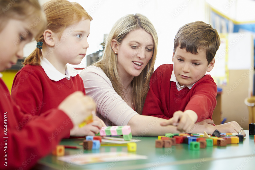 Pupils And Teacher Working With Coloured Blocks Pupils And Teacher Working With Coloured Blocks