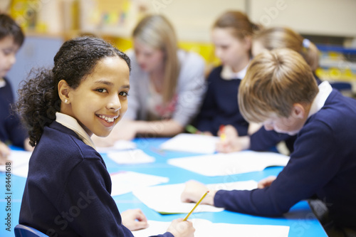 Portrait Of Pupil In Classroom With Teacher photo