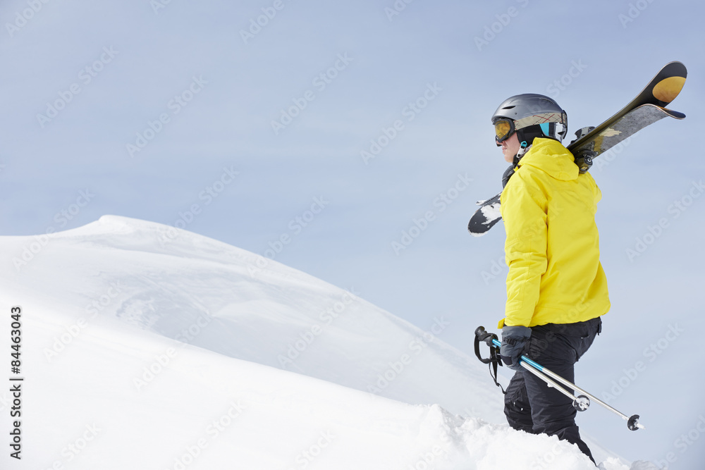 Man With Skis On Holiday In Mountains