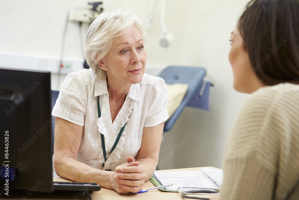 Female Consultant Meeting With Teenage Patient Female Consultant Meeting With Teenage Patient