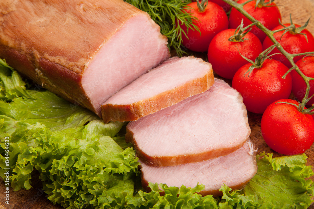 Smoked meat with bright summer vegetables on wooden background Smoked meat with bright summer vegetables on wooden background