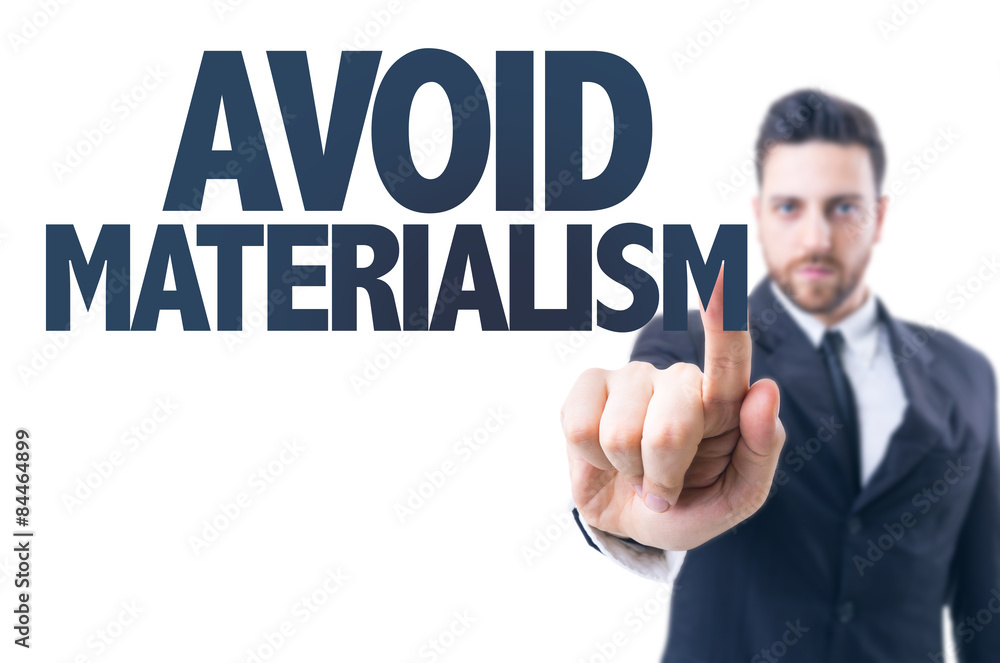 Business man pointing the text: Avoid Materialism Business man pointing the text: Avoid Materialism