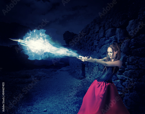 Konstfotografi woman witch cast magic - cold ball of ice