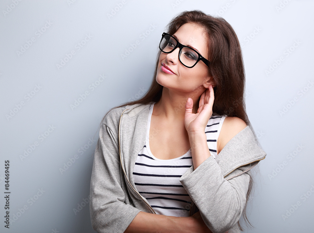 Thoughtful young casual woman looking on empty copy space
