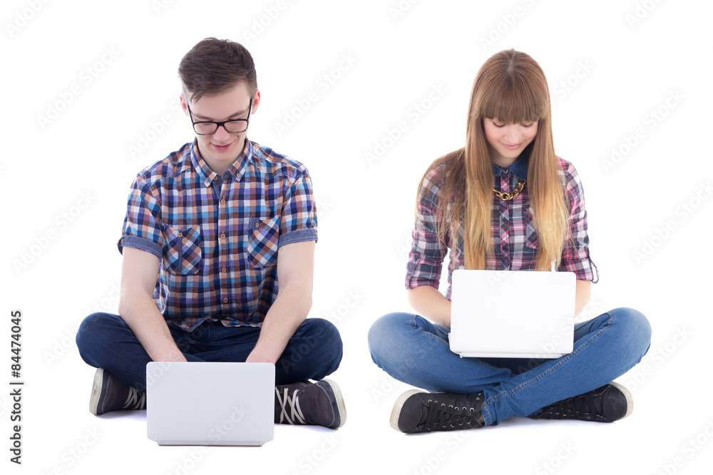 teenage boy and girl sitting with computers isolated on white teenage boy and girl sitting with computers isolated on white
