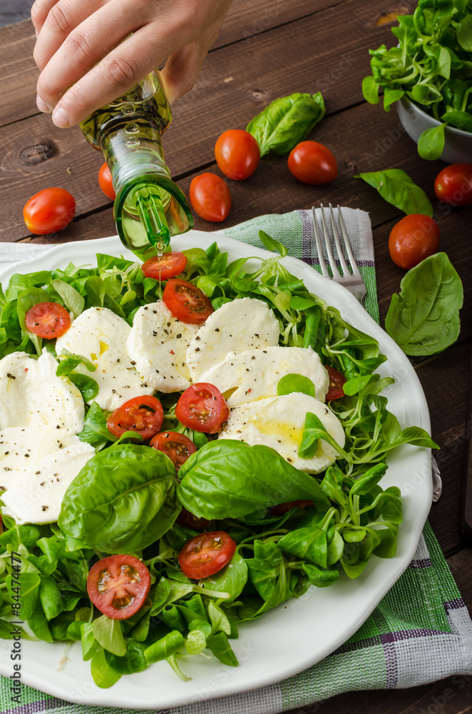 Lamb's lettuce salad with mozzarella, tomato and basil Lamb's lettuce salad with mozzarella, tomato and basil