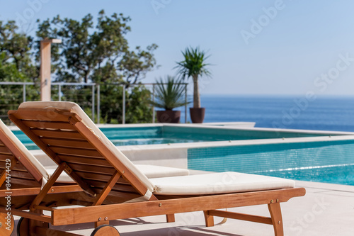 Фотография Luxury swimming pool and deck chair