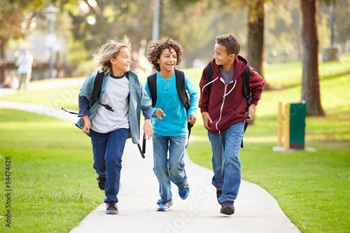 Group Of Young Boys Running Towards Camera In Park