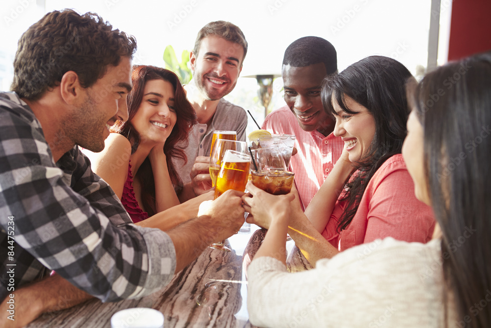 Group Of Friends Enjoying Drink At Outdoor Rooftop Bar Group Of Friends Enjoying Drink At Outdoor Rooftop Bar
