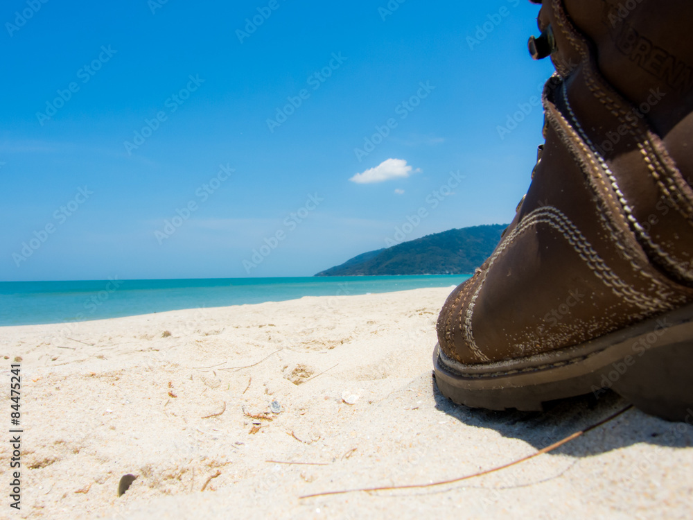Obraz premium Leather shoes sneaker on beach in Thailand Welcome to summer Season in thailand ,Concept Vacation,Holiday,Tourism,Relax,Travel