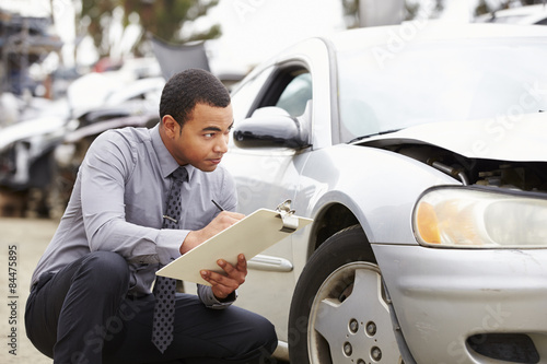 Loss Adjuster Inspecting Car Involved In Accident photo