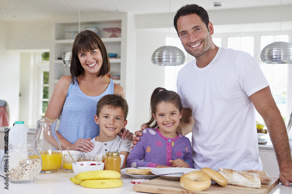 Family Making Breakfast In Kitchen Together