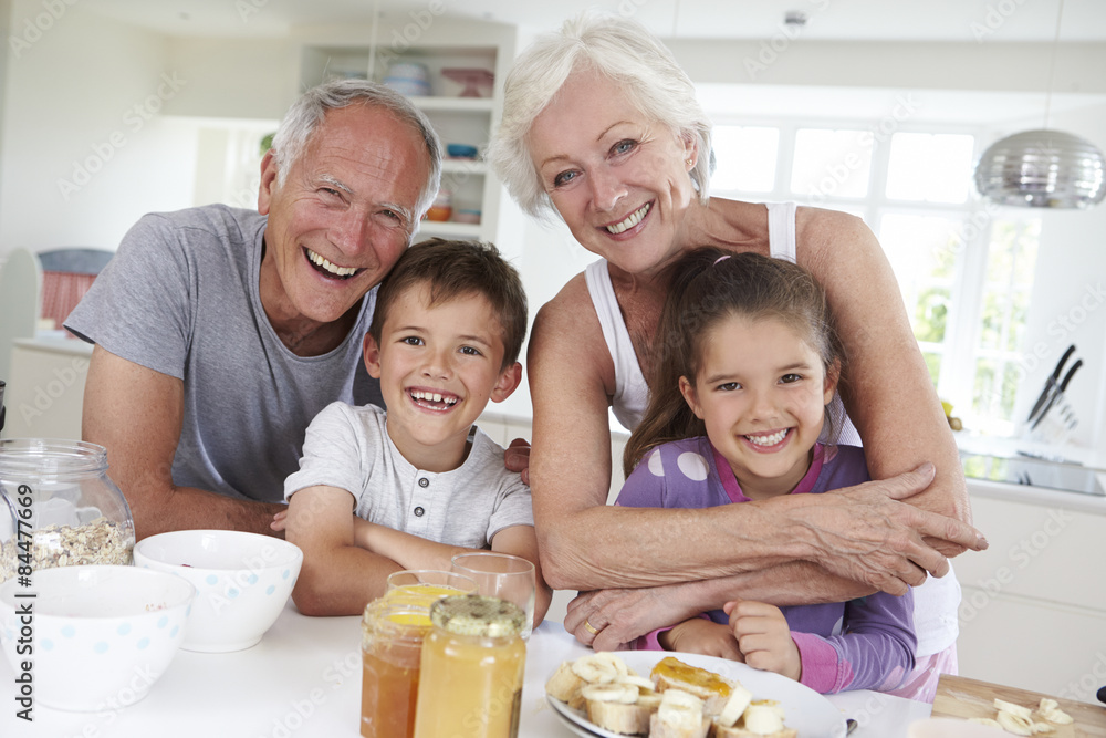 Grandparents With Grandchildren Eating Breakfast In Kitchen Stock Photo ...