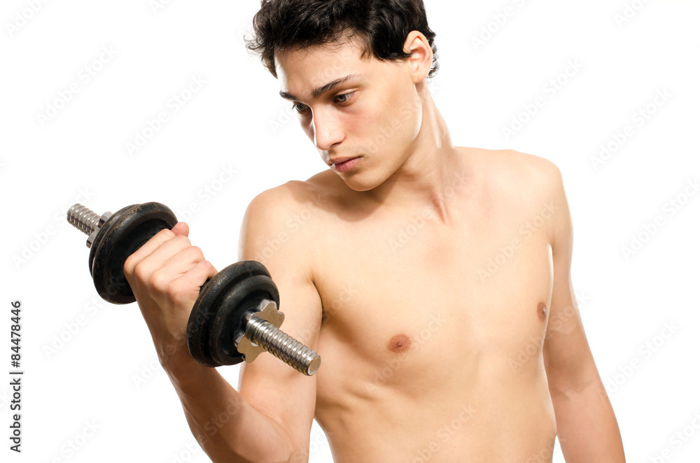 Skinny man training his bicep muscle. Beautiful teenager lifting a dumbbell.Anorexic young man training to become stronger Skinny man training his bicep muscle. Beautiful teenager lifting a dumbbell.Anorexic young man training to become stronger