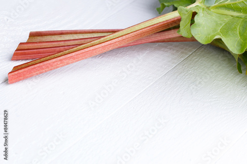 Rhubarb on white wooden table.