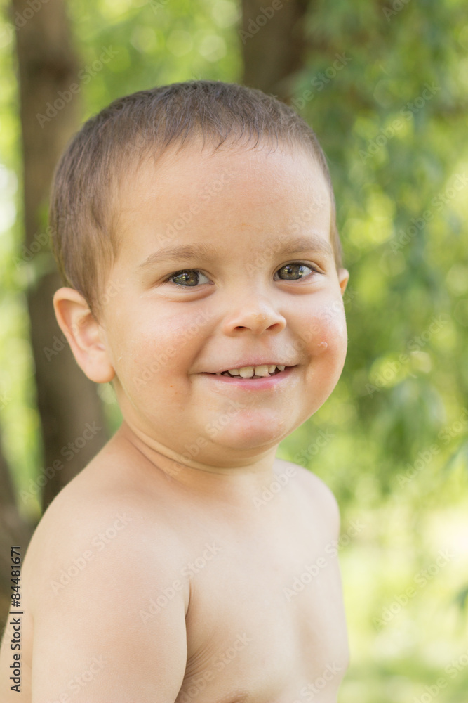 a little boy, two years old, smiling, summer, naked to the waist a little boy, two years old, smiling, summer, naked to the waist