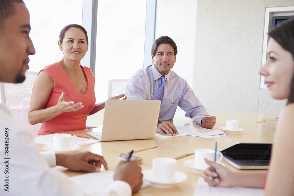 Four Hispanic Businesspeople Having Meeting In Boardroom Four Hispanic Businesspeople Having Meeting In Boardroom