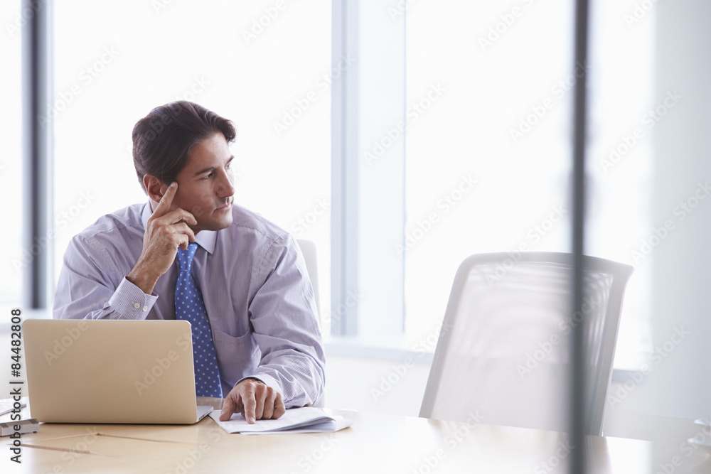 Businessman Working On Laptop At Boardroom Table Businessman Working On Laptop At Boardroom Table