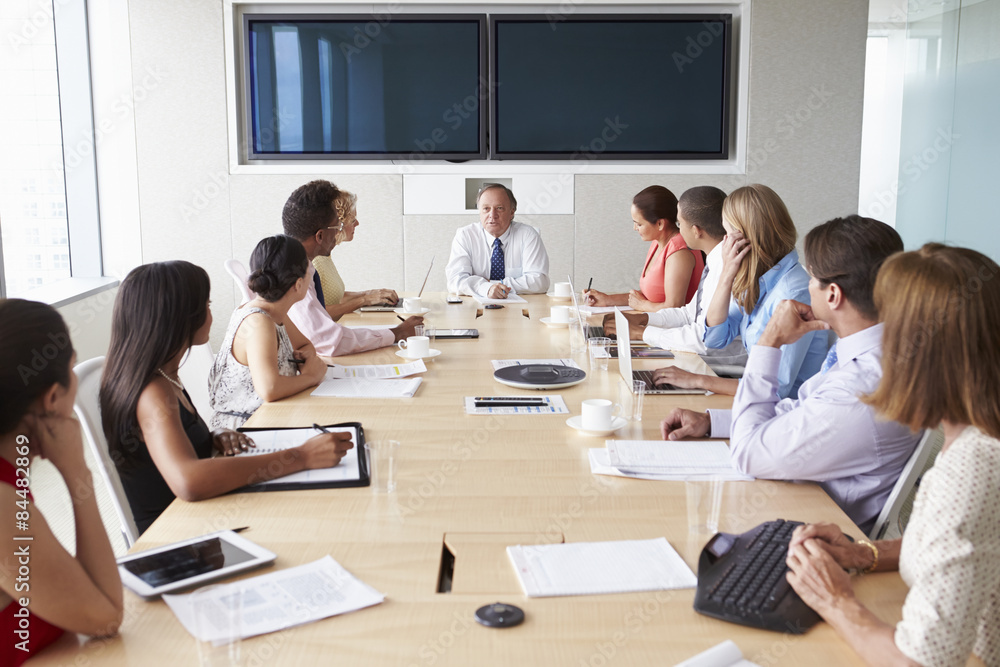 Fototapeta premium Group Of Businesspeople Meeting Around Boardroom Table