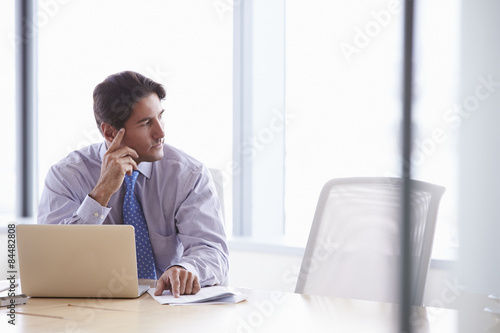 Businessman Working On Laptop At Boardroom Table