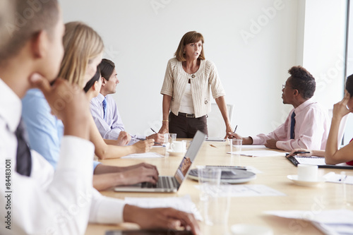 Group Of Businesspeople Meeting Around Boardroom Table