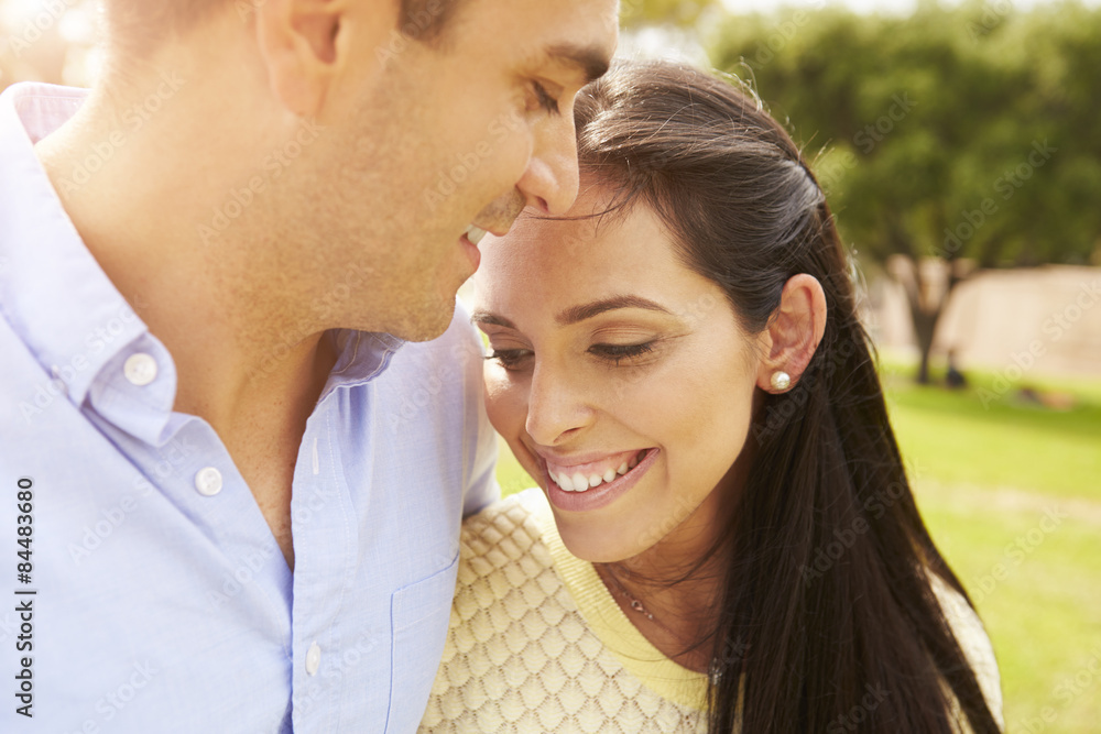 Fototapeta premium Young Hispanic Couple Walking In Park Together