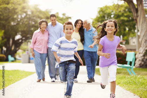 Multi Generation Family Walking In Park Together