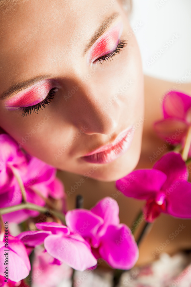 Pretty beautiful relaxing woman with purple orchids Pretty beautiful relaxing woman with purple orchids