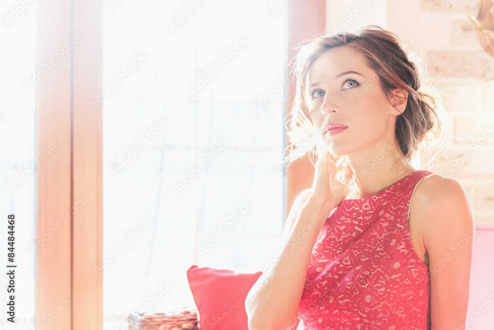 Beautiful brunette woman sitting near a sunny window Beautiful brunette woman sitting near a sunny window