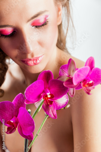 Pretty beautiful relaxing woman with purple orchids
