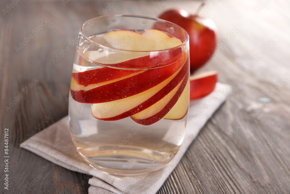 Glass of apple cider with fruits on wooden background Glass of apple cider with fruits on wooden background