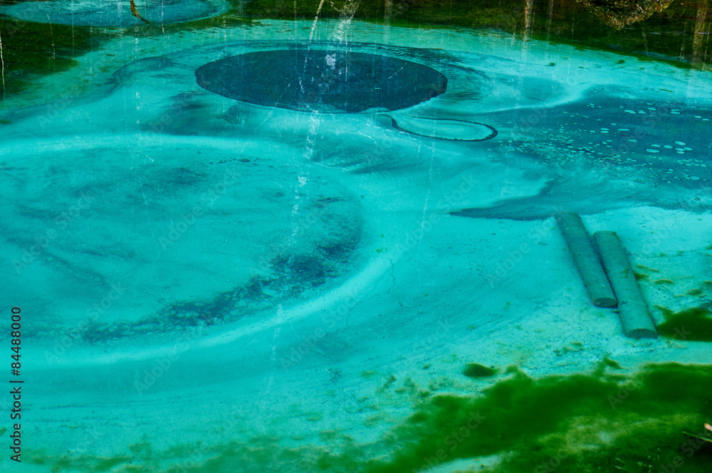 Geyser lake with clear cyan water in Altai mountains