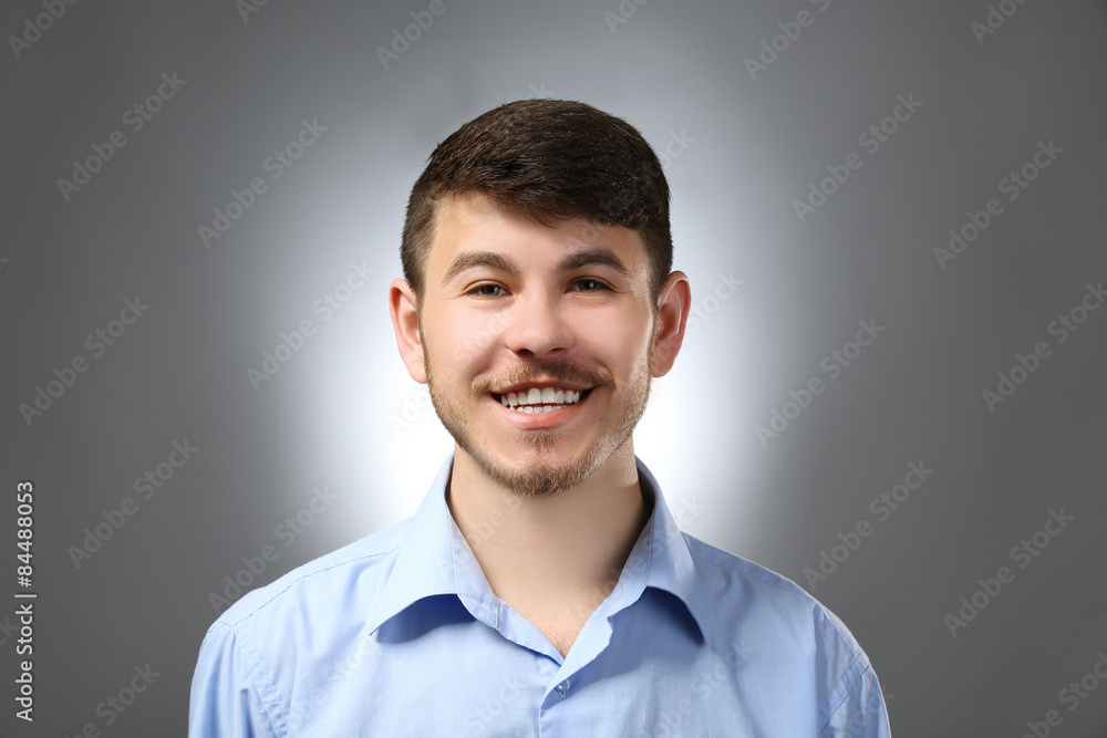 Portrait of smiling man on gray background Portrait of smiling man on gray background