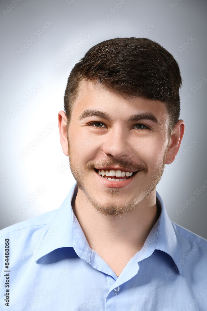 Portrait of smiling man on gray background Portrait of smiling man on gray background