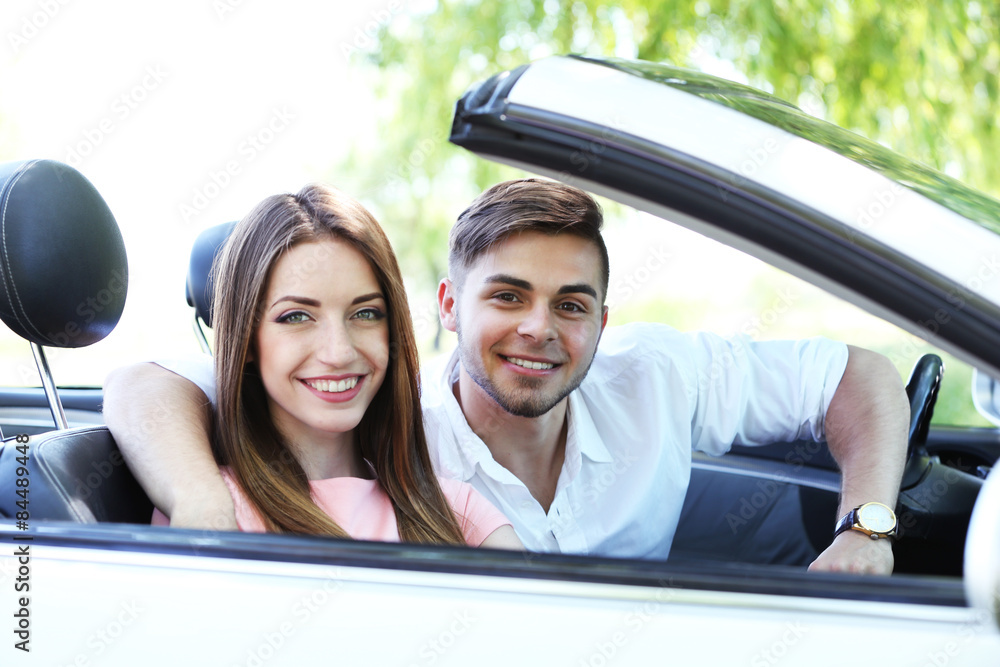 Young couple in cabriolet, outdoors