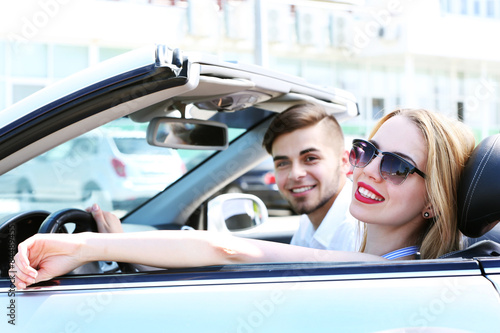 Young couple in cabriolet, outdoors © Africa Studio