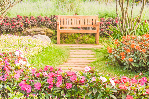 Beautiful wooden chairs in the flower garden
