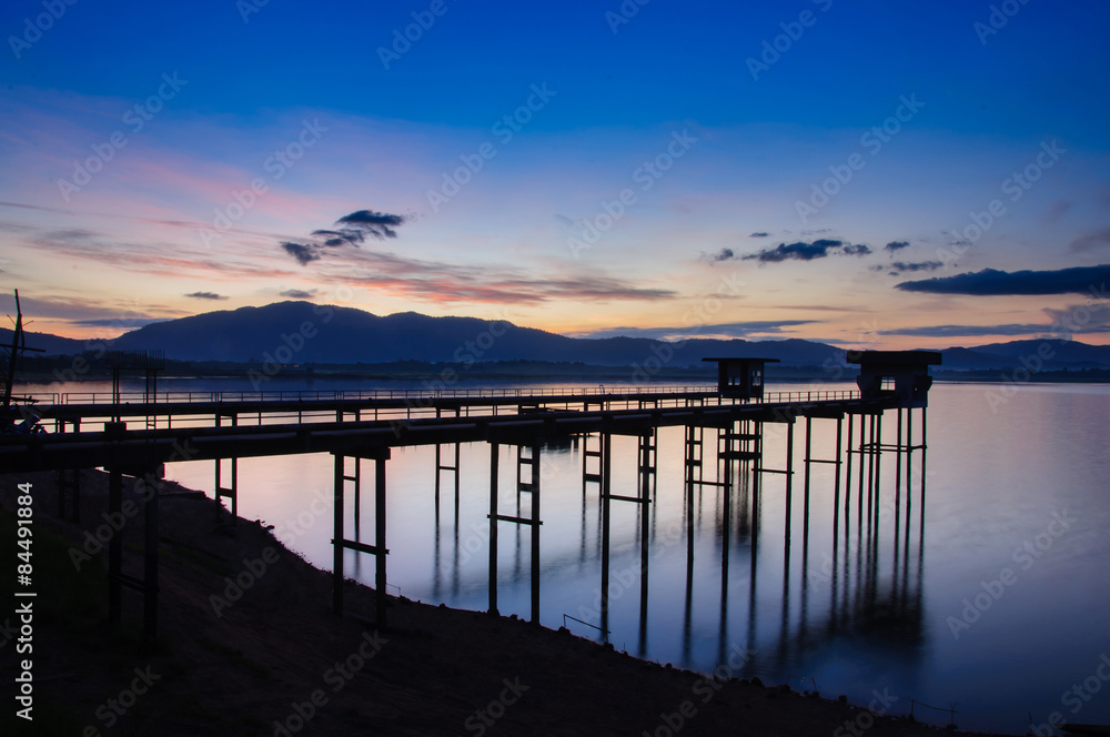 old bridge at the lake with sunrise.