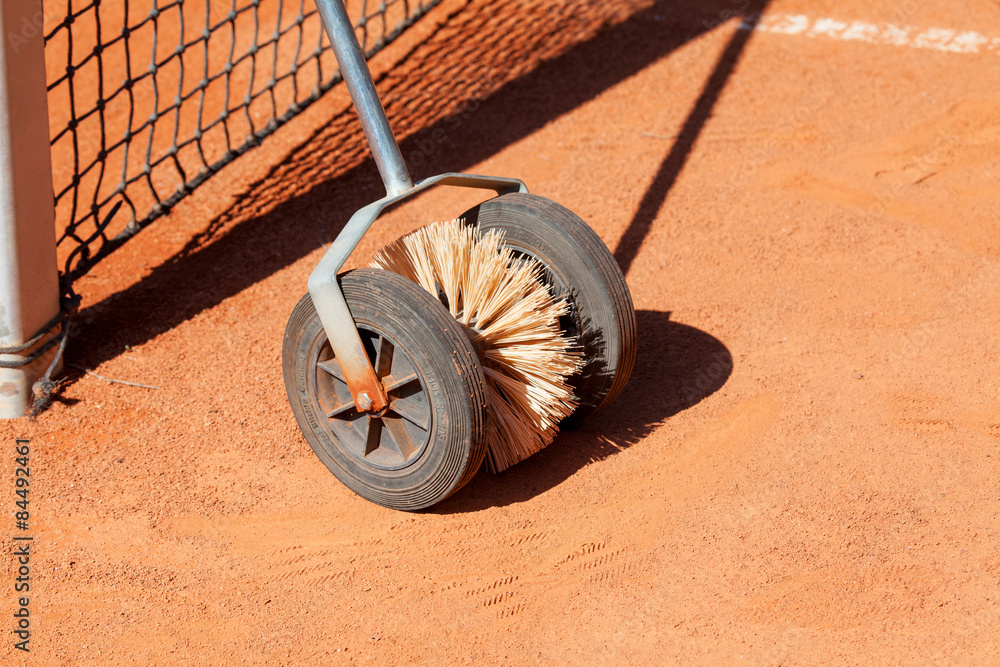 Clay tennis court. Brush.