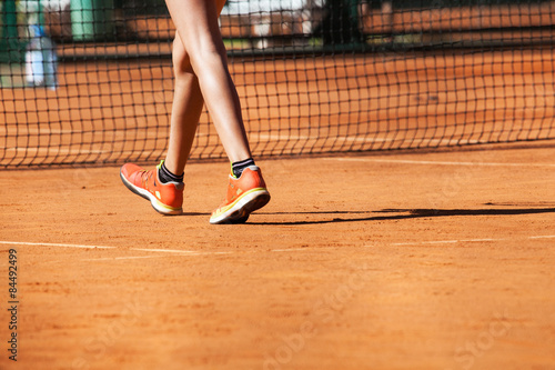 Clay tennis court with Tennis player legs.