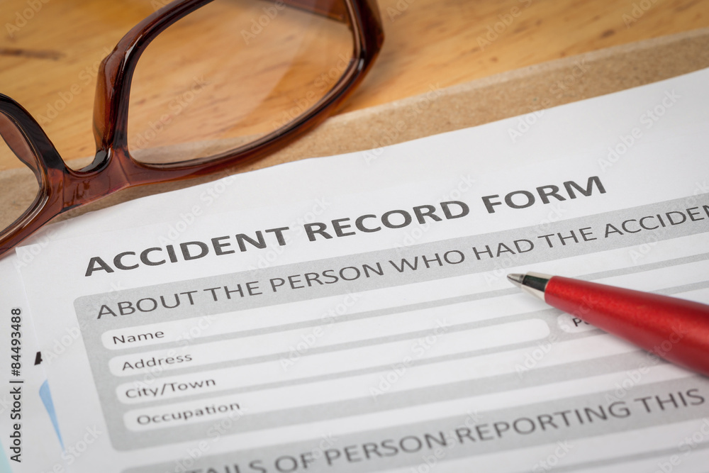 Accident report application form and pen on brown envelope and e Accident report application form and pen on brown envelope and e