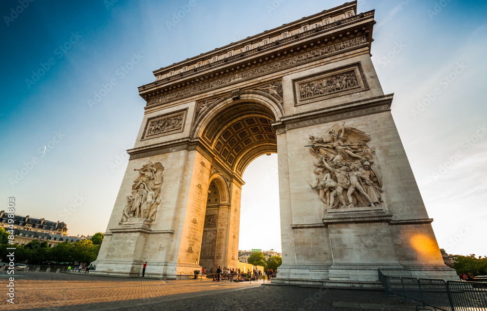 Triumphal Arch at the end of Champs-Elysees street before sunset