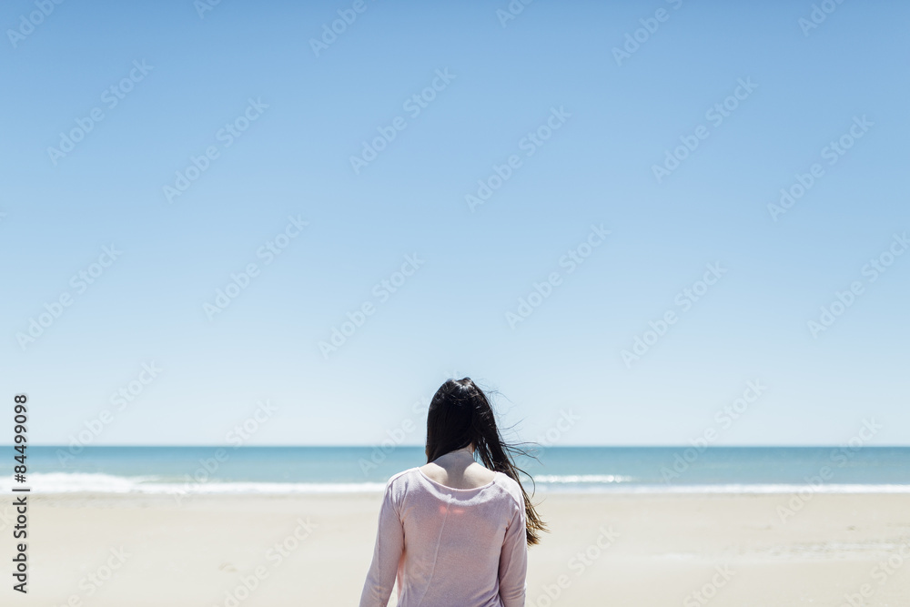 Young beautiful woman near the sea at spring